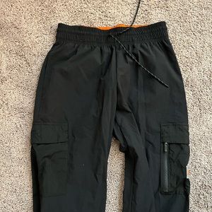 Nike cargo track pants fit black with orange detail never worn size Small